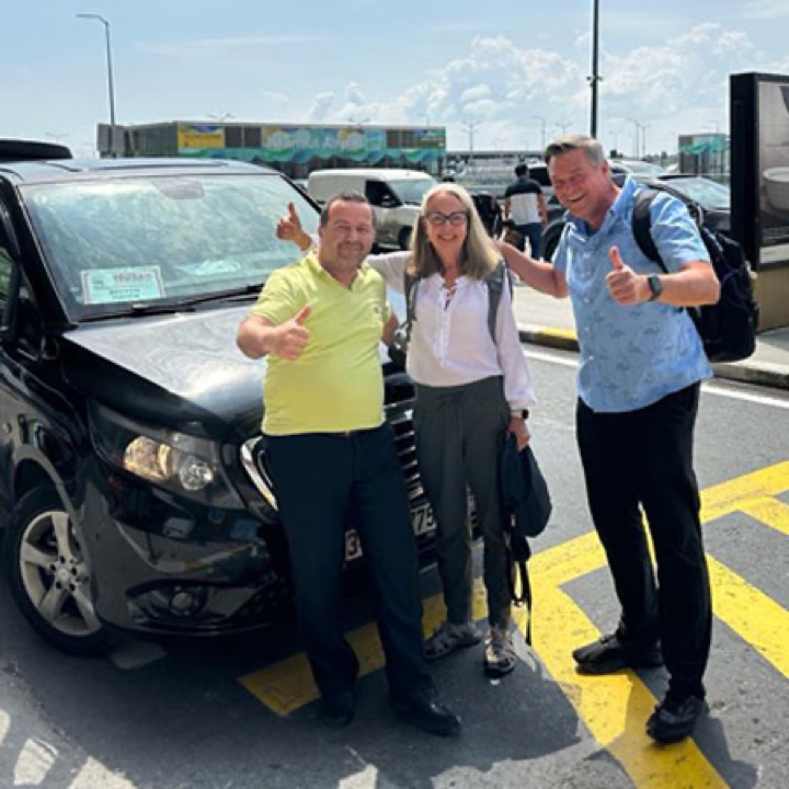 Happy customers at Antalya Airport with their taxi
